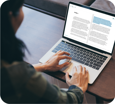 Pessoa estudando em notebook com material digital, representando o ensino a distância.